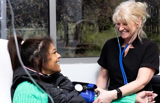 Nurse helping an infusion patient