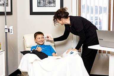 Young boy getting medical transfusion